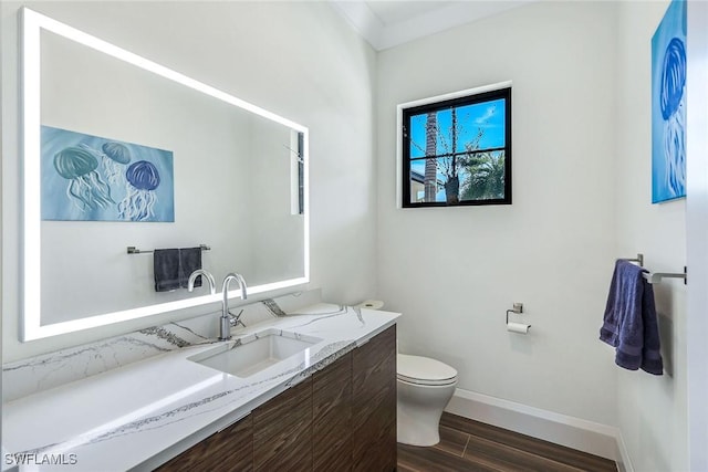 bathroom featuring hardwood / wood-style floors, vanity, and toilet