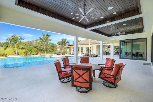 view of pool with ceiling fan and a patio