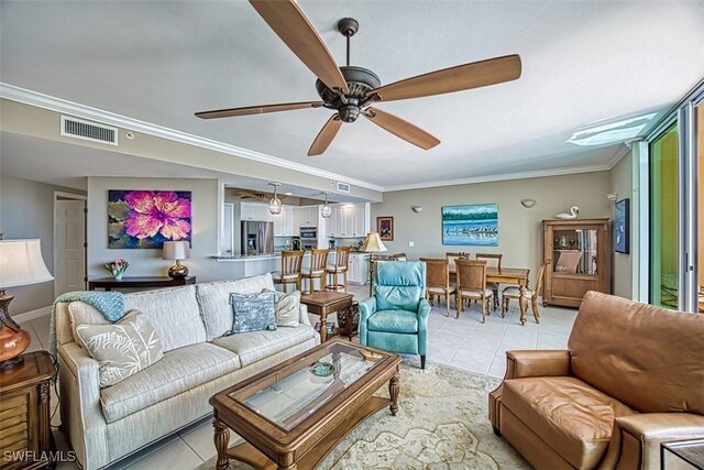 living room featuring ceiling fan, ornamental molding, and light tile patterned floors