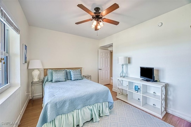 bedroom with ceiling fan and wood-type flooring