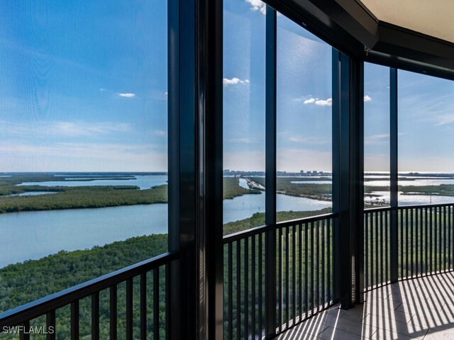 unfurnished sunroom with a water view