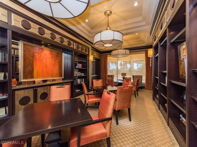 office area with a tray ceiling and crown molding