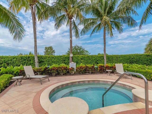 view of pool with a community hot tub