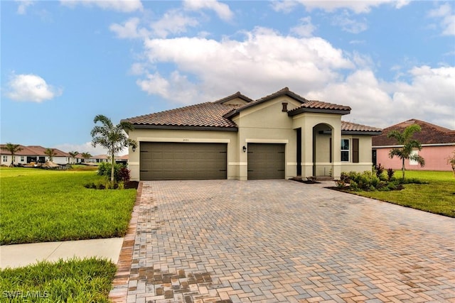 mediterranean / spanish-style home with a garage and a front yard