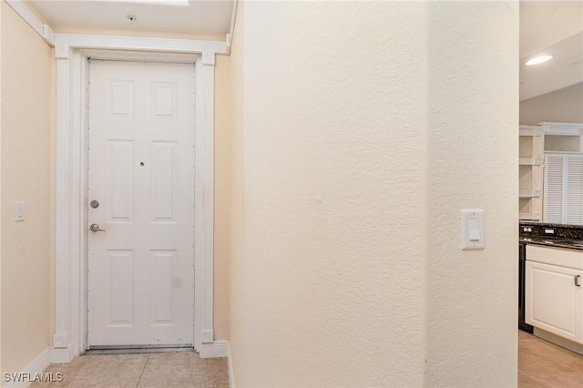 corridor featuring light tile patterned floors