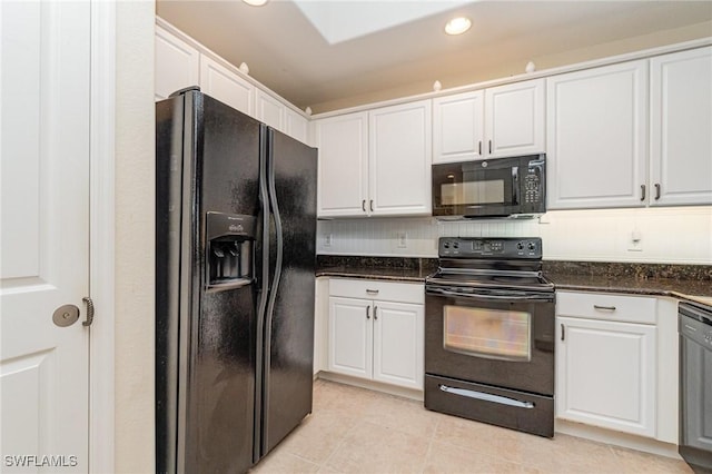 kitchen with black appliances, dark stone countertops, white cabinetry, and light tile patterned floors