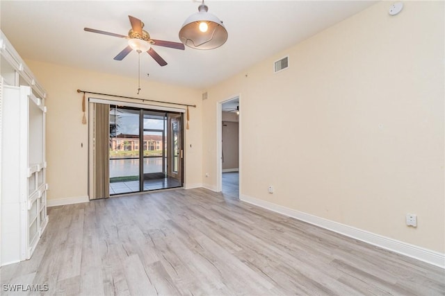 spare room featuring ceiling fan and light hardwood / wood-style flooring