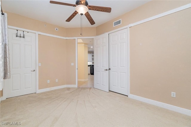 unfurnished bedroom with light carpet and ceiling fan