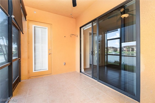 entryway featuring ceiling fan and tile patterned floors