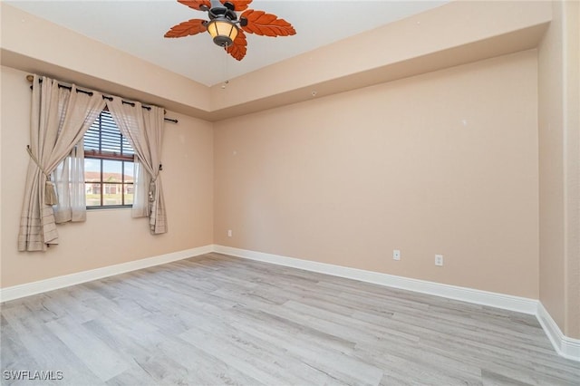 empty room featuring ceiling fan and light hardwood / wood-style flooring