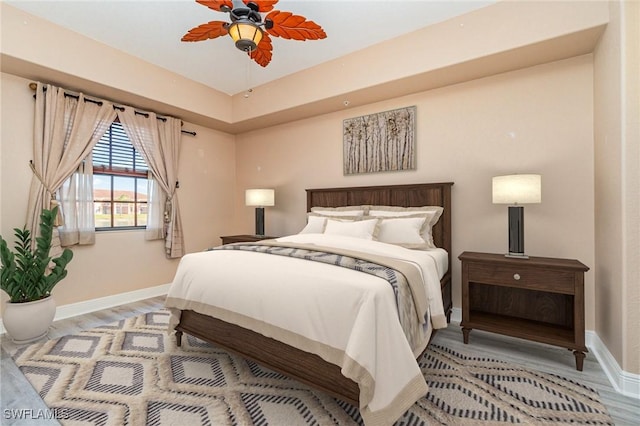 bedroom featuring light wood-type flooring, ceiling fan, and baseboards