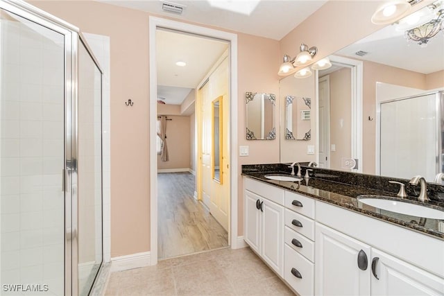 bathroom featuring hardwood / wood-style floors, vanity, and walk in shower