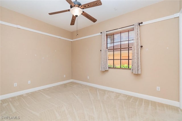 empty room featuring light carpet and ceiling fan