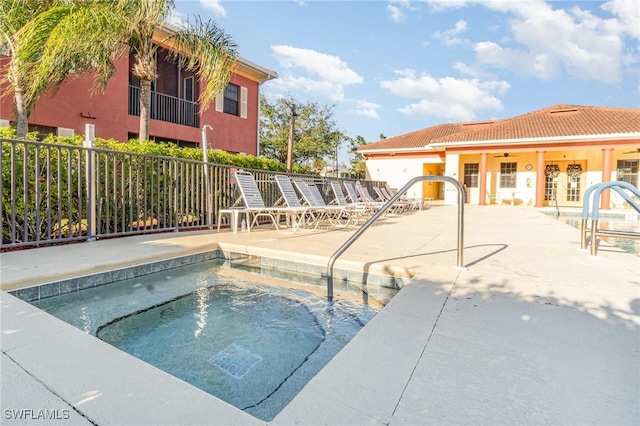 view of swimming pool with an in ground hot tub and a patio