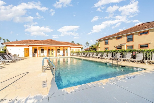 pool with fence and a patio