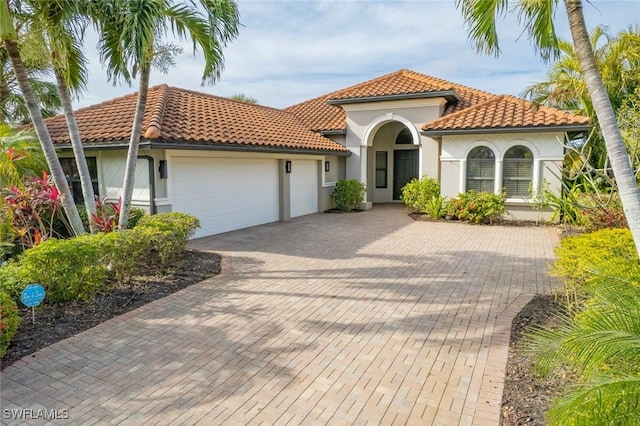 mediterranean / spanish-style house featuring a garage