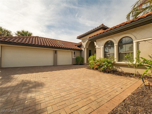 mediterranean / spanish-style house featuring a garage