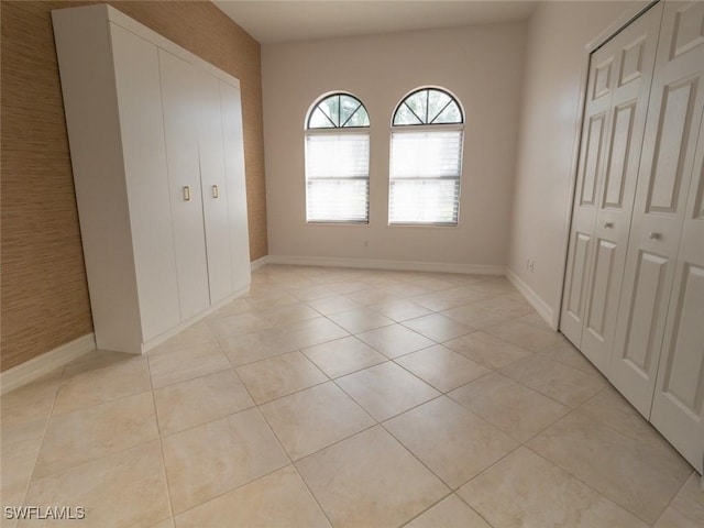 unfurnished bedroom with light tile patterned flooring