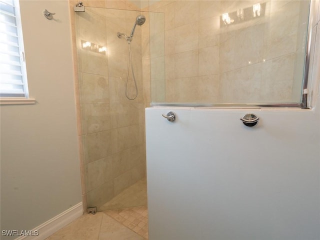 bathroom featuring tile patterned floors and tiled shower