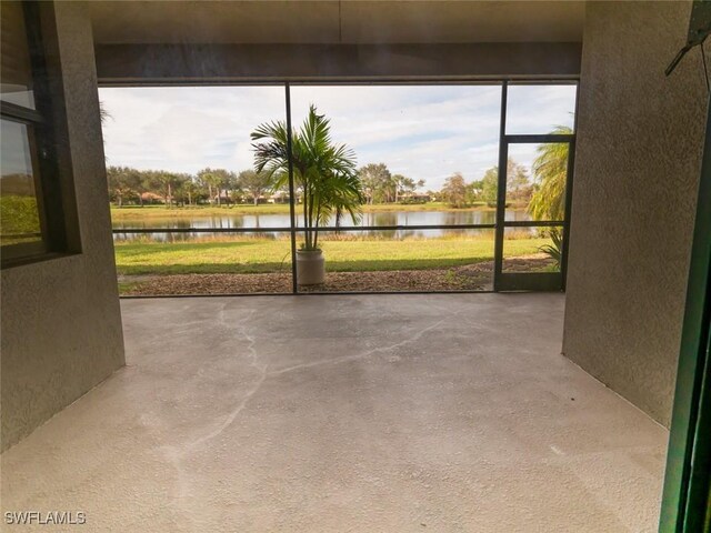 unfurnished sunroom with a water view and a wealth of natural light