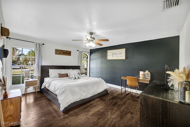 bedroom with dark hardwood / wood-style flooring and ceiling fan