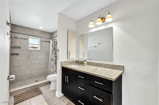 bathroom with toilet, tile patterned flooring, vanity, and curtained shower