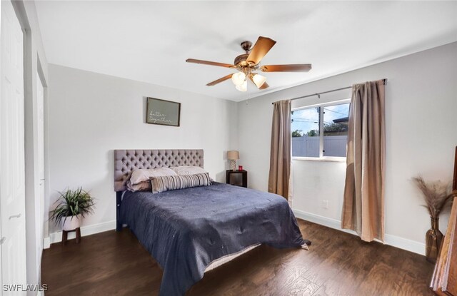 bedroom with ceiling fan and dark hardwood / wood-style floors