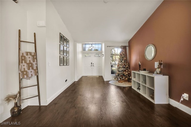 entrance foyer featuring dark wood-type flooring and vaulted ceiling