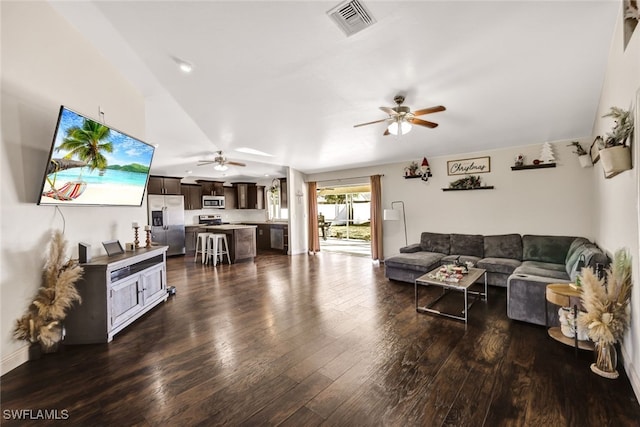 living room with ceiling fan and dark wood-type flooring