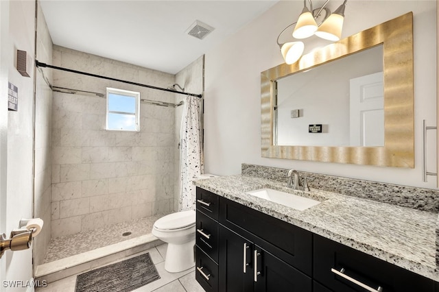 bathroom featuring tile patterned flooring, vanity, curtained shower, and toilet