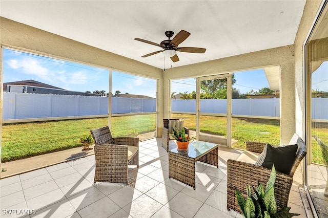 sunroom / solarium with ceiling fan and a healthy amount of sunlight