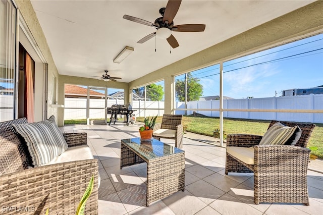 sunroom featuring ceiling fan