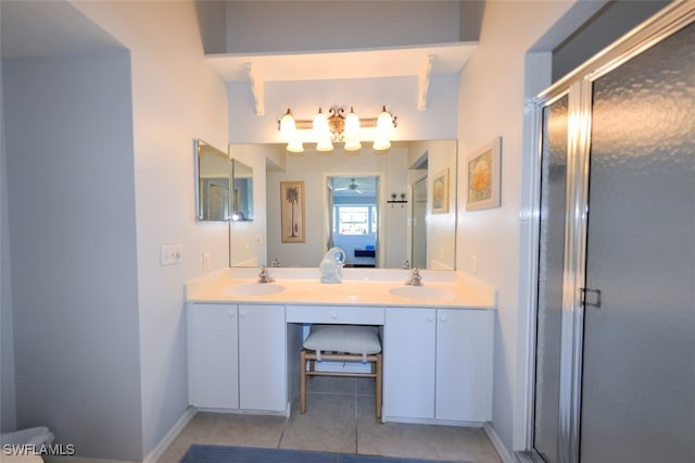 bathroom with tile patterned floors, ceiling fan, vanity, and an enclosed shower