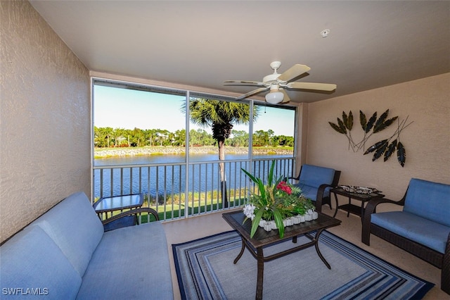 exterior space with ceiling fan and a water view