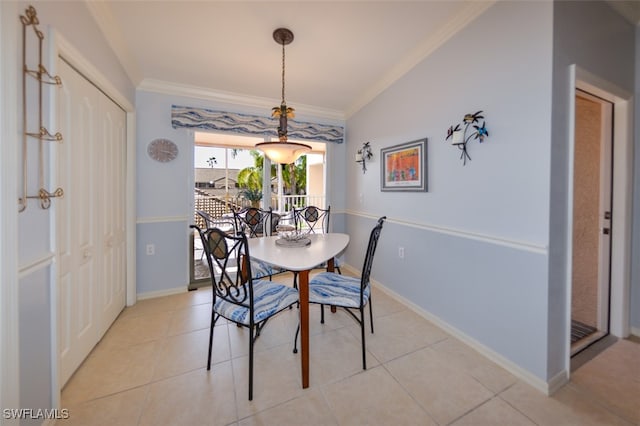 dining space with light tile patterned floors and ornamental molding