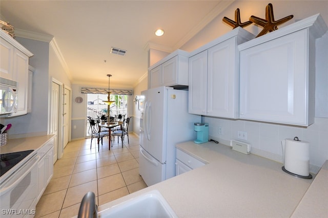 kitchen featuring white cabinets, hanging light fixtures, and lofted ceiling