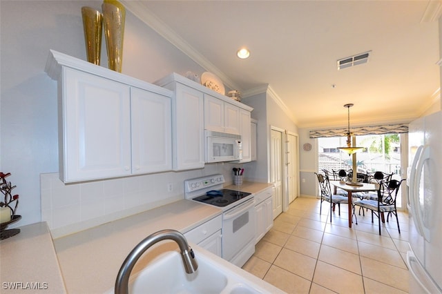 kitchen with white cabinetry, crown molding, vaulted ceiling, white appliances, and light tile patterned floors