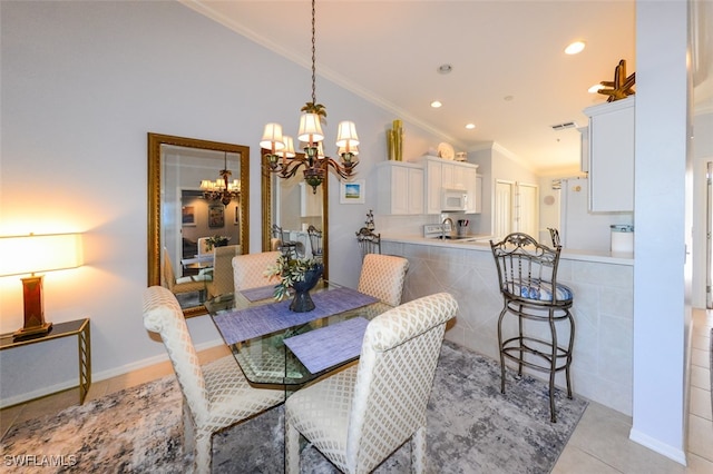 tiled dining space featuring a chandelier, ornamental molding, and lofted ceiling