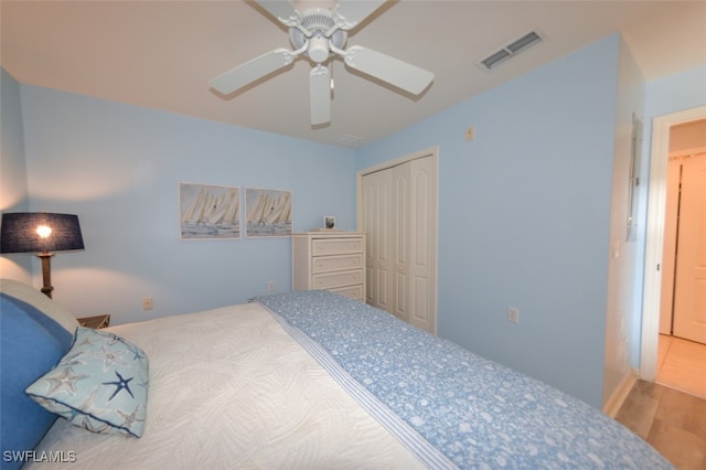 bedroom with ceiling fan, a closet, and hardwood / wood-style flooring