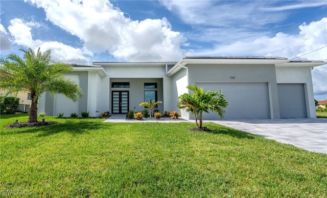 view of front of property with french doors, a front yard, and a garage