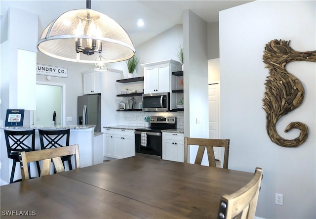 dining room featuring an inviting chandelier and sink