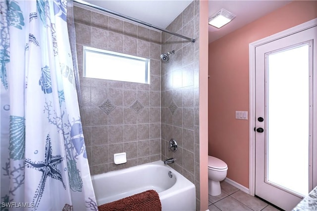 bathroom with tile patterned floors, shower / bath combination with curtain, and toilet