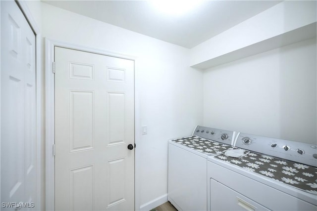 washroom featuring washer and clothes dryer