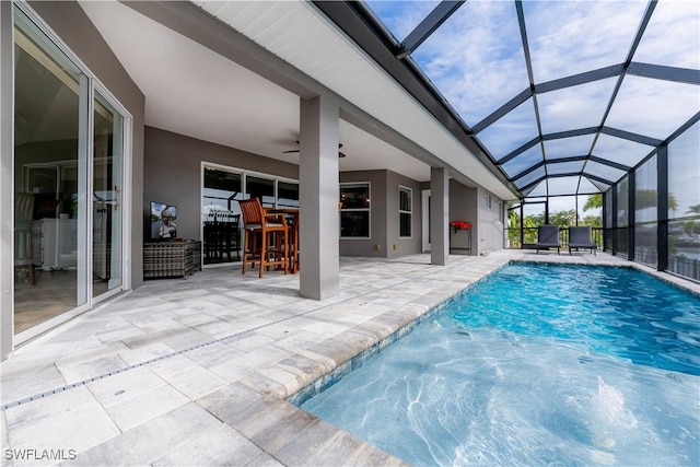 view of pool featuring glass enclosure and a patio