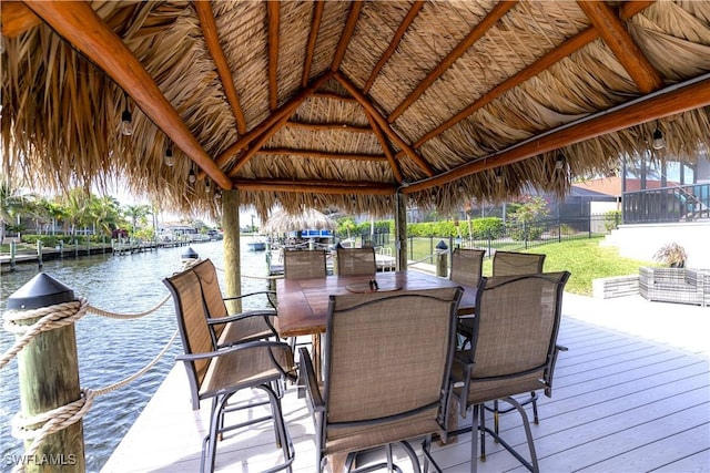 view of dock with a gazebo and a water view