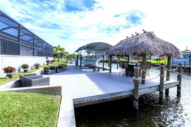 dock area with glass enclosure and a water view