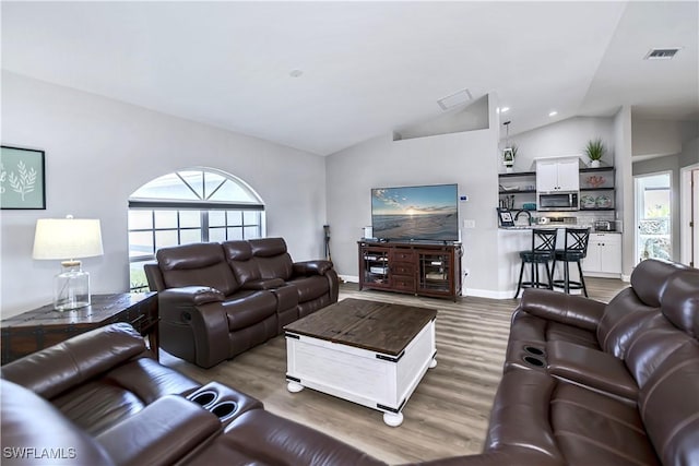 living room featuring dark hardwood / wood-style flooring and lofted ceiling