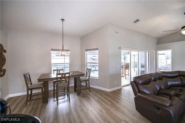 dining space featuring hardwood / wood-style flooring, ceiling fan, and lofted ceiling