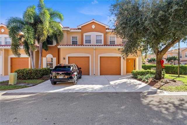 mediterranean / spanish-style house with a garage