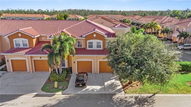 mediterranean / spanish-style house featuring a residential view, driveway, a tiled roof, and stucco siding